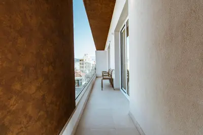 an empty corridor of a building with a window at ANTEL Suites & Apartments in Chania Town