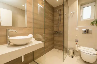 a bathroom with a toilet and a sink and a shower at ANTEL Suites & Apartments in Chania Town
