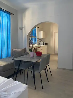 a living room with a table and chairs and a bed at Casa Argo in Chania Town