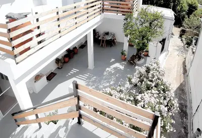 an overhead view of a balcony with a bench and flowers at Casa Elafonisi N2-10min from the beach in Plokamianá