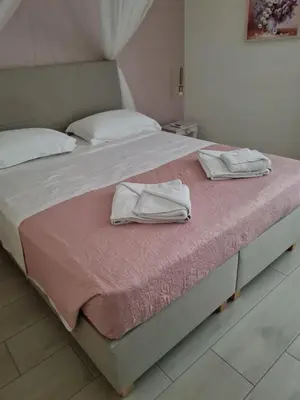a bed with two towels sitting on top of it at Belle Verte City Chania in Chania Town