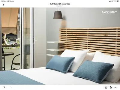 a bedroom with a bed with two blue pillows at Chania Center Apartment in Chania Town