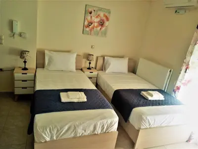 a bedroom with two beds with towels on them at Alkioni City Apartments in Chania Town