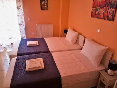 a bedroom with two beds with towels on them at Alkioni City Apartments in Chania Town