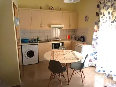 a small kitchen with a table and chairs in it at Alkioni City Apartments in Chania Town