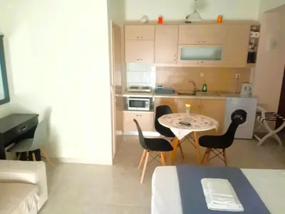 a small kitchen with a table and chairs in a room at Alkioni City Apartments in Chania Town