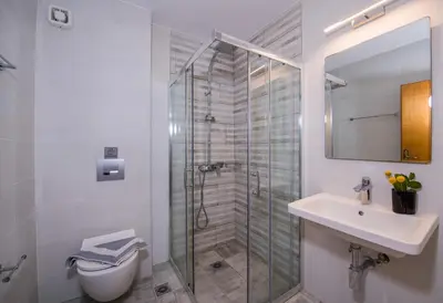 a bathroom with a shower and a toilet and a sink at Giannarakis Beach in Stalos