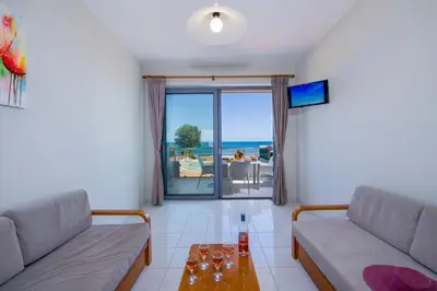 a living room with a couch and a table at Giannarakis Beach in Stalos