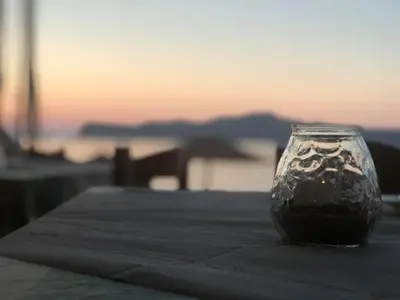 a glass vase sitting on top of a table at Kato Stalos Mare in Stalos