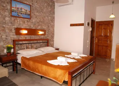 a bedroom with a bed with white towels on it at Kato Stalos Mare in Stalos
