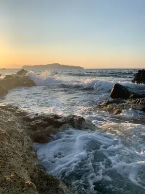a view of the ocean with waves crashing on the rocks at Ouranos Studios in Kalamaki Chanion
