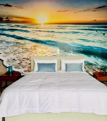 a bed on the beach at sunset at Ouranos Studios in Kalamaki Chanion