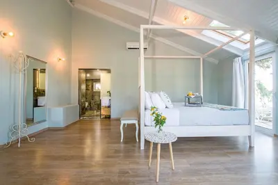 a bedroom with a bed and a table with flowers on it at Casa di Goya in Chania Town