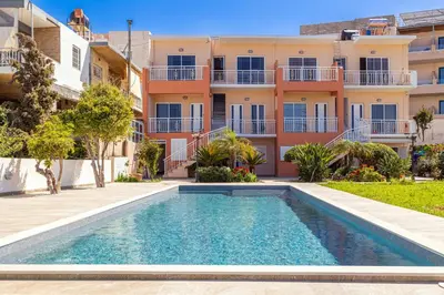 an image of a swimming pool in front of a building at CHRISTINE SEASIDE APARTMENTS IN CHANIA in Stalos