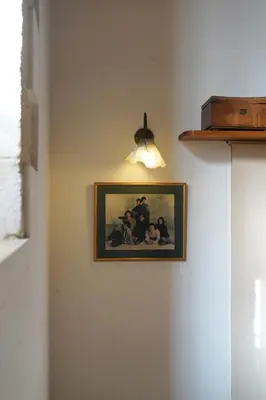a picture hanging on a wall with a light at Lindas Convent Garden Home 4 in Chania Town