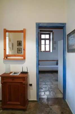 a room with a mirror and a dresser and a door at Lindas Convent Garden Home 4 in Chania Town
