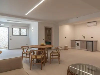 a kitchen and dining room with a table and chairs at Amalthia Villa, Heated Pool & Walk to the Beach, By ThinkVilla in Tavronitis