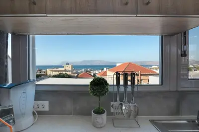 a kitchen with a window with utensils on a counter at Calliope Rooms in Kissamos
