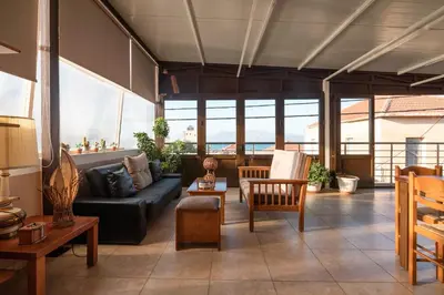 a living room with a couch and chairs at Calliope Rooms in Kissamos