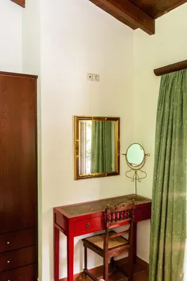 a dressing room with a mirror and a wooden desk at Arhontika Villas in Élos