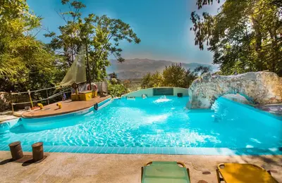 a pool at a resort with a water slide at Malaxiana Houses in Maláxa