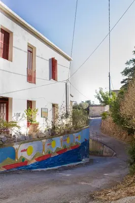 a building with a mural on the side of it at Malaxiana Houses in Maláxa