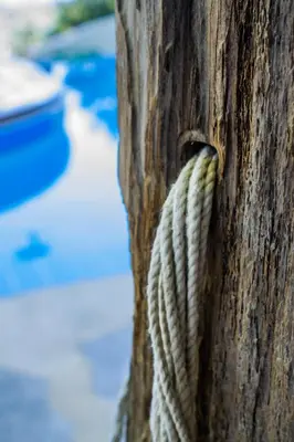 a rope hanging from the side of a wooden pole at Malaxiana Houses in Maláxa