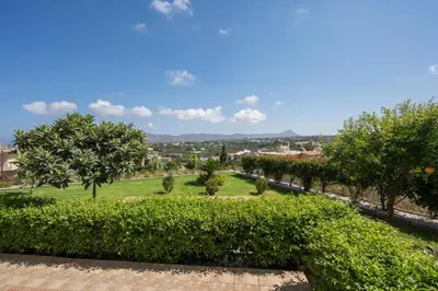 a view of a park with trees and bushes at Tholos Apartments in Chania Town