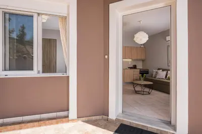 a view of a living room and kitchen from the hallway of a house at Tholos Apartments in Chania Town