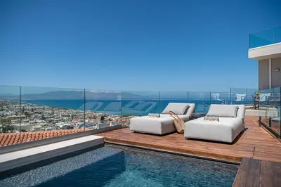 a house with a swimming pool and a view of a city at Alectrona Living Crete, Apartment RocSea in Plataniás