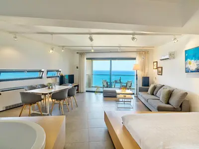 a living room with a couch and a table at Alectrona Living Crete, Apartment RocSea in Plataniás