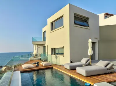 a villa with a swimming pool and a house at Alectrona Living Crete, Apartment RocSea in Plataniás