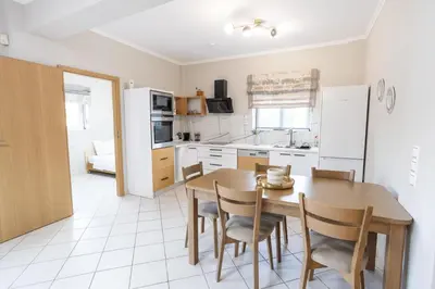 a kitchen and dining room with a table and chairs at Sofia's seaview house in Plataniás