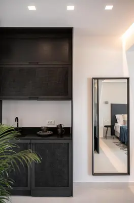 a mirror in a room next to a bedroom at Nuovo Luxury Suites in Daratso