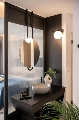 a bathroom with a sink on a black counter at Nuovo Luxury Suites in Daratso
