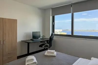 a bedroom with a desk with a computer and a window at Villa Valentina Chania in Kalathas