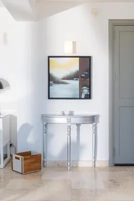 a table in a room with a picture on the wall at Seacrete villas in Chania Town