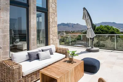 a living room with a couch and a table at Seacrete villas in Chania Town