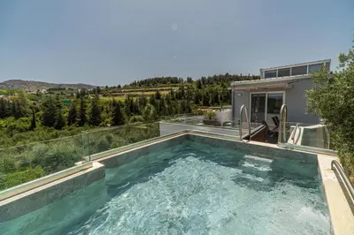 a swimming pool in the backyard of a house at Villa Eftychia - villa with 2 private pools!!! by PosarelliVillas in Almirida