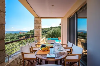 a table and chairs on a balcony with a view at Margarita's Villas in Chania Town