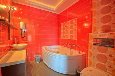 a red bathroom with a tub and a sink at Cabanavillas MILANO by PosarelliVillas in Agia Marina Nea Kydonias