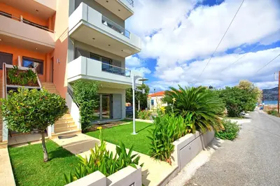 a house with a green yard with plants at Cabanavillas MILANO by PosarelliVillas in Agia Marina Nea Kydonias