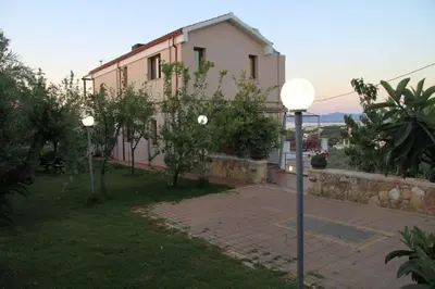 a house with two street lights in front of it at Villa Koulouridi Agritourism in Daratso