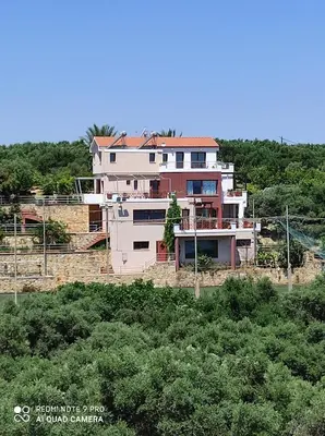 a large house sitting on top of a hill at Villa Koulouridi Agritourism in Daratso