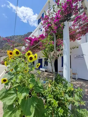 a building with flowers in front of it at Hotel Agia Roumeli by the SEA in Agia Roumeli