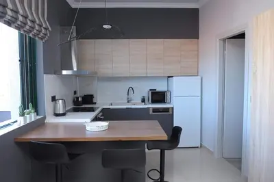 a kitchen with a wooden counter top and a refrigerator at Phaedra's Studios in Kolymbari in Chania Town
