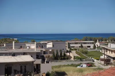 a view of a town with houses and the ocean at Phaedra's Studios in Kolymbari in Chania Town
