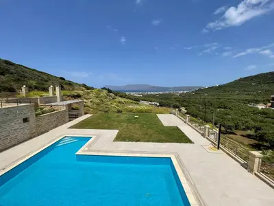 a swimming pool in the backyard of a house at Mitato Stylianos in Kounoupítsa