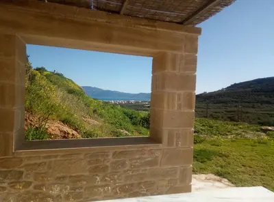 a window in a building with a view of a hill at Vilitsa Stylianos in Kounoupítsa