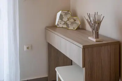 a wooden shelf with a mirror on top of it at Casa Gardenia-modern apartment next to the beach, near Old Town in Chania Town